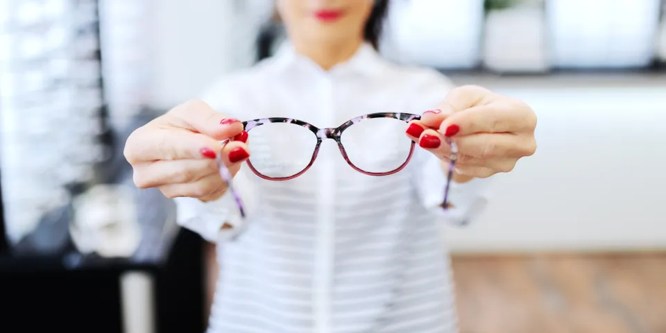 woman holding glasses