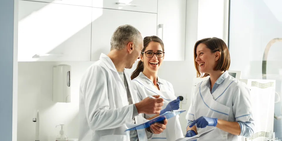 dental office team laughing together